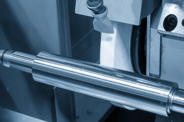 Close Up of Cylindrical Grinding Machine Working on Metal Shaft Parts