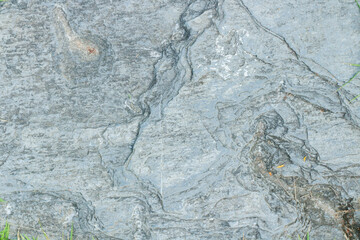 Naklejka premium Close-up view of granite laid on grass lawn, creating a natural