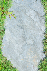 Naklejka premium Close-up view of granite laid on grass lawn, creating a natural