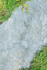 Naklejka premium Close-up view of granite laid on grass lawn, creating a natural