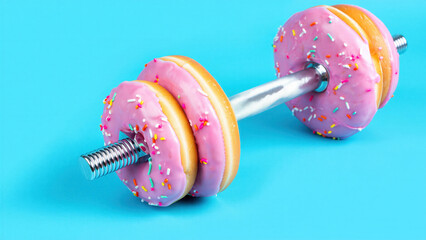 Pink frosted donut dumbbell on turquoise background, fitness dessert contrast, sugary snack training opposition, gym discipline challenge, diet temptation conflict, playful workout lifestyle tension