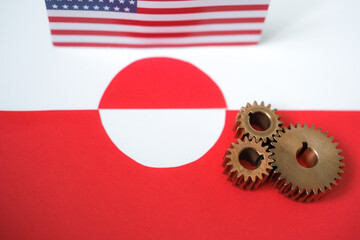 United States and Greenland relations concept with metal gears and blurred flags. Arctic diplomacy and strategic interests. 
