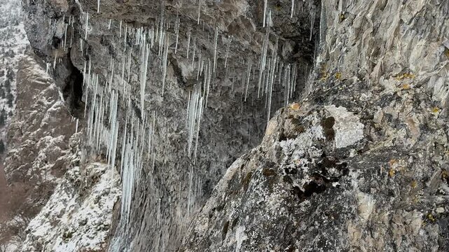 the icicles hanging from the ceiling of the rock in the cold winter texture