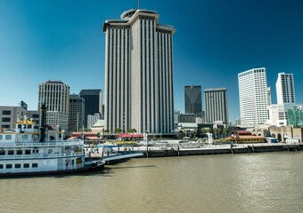 Ferry boat perspective showing vibrant New Orleans waterfront and Riverwalk architecture