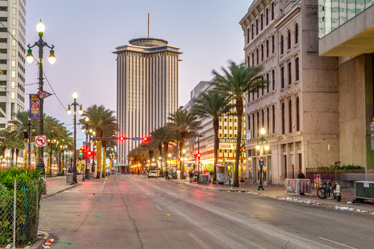 Urban streetscape of New Orleans showing buildings lit up during nighttime city scene