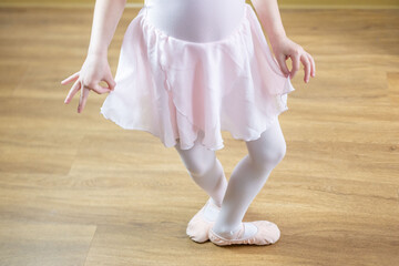 young aspiring ballerina, 5 years old, dances in soft pink leotard, embodying childhood passion, elegance, and artistic expression