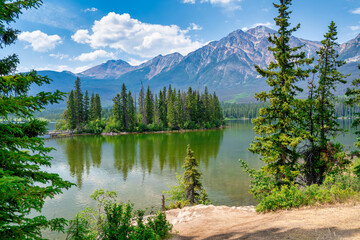 Tranquil Pyramid Island on Pyramid Lake, surrounded by stunning mountain scenery in Jasper