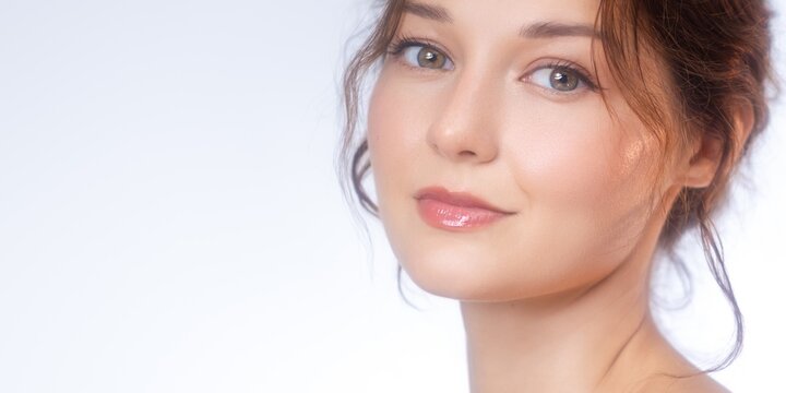 Closeup Portrait Of Smiling Young Woman With Glowing Natural Skin