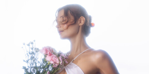 Elegant Woman Holding Flowers in Soft Backlight for Romantic Concept