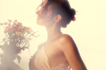 Elegant Beauty Portrait Of Woman With Flower Bouquet In Dreamy Warm Lighting