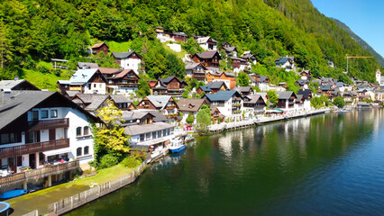 Stunning aerial view of Hallstatt, showcasing the picturesque village and serene lake nestled in...