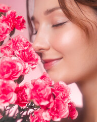 Serene Woman Smelling Pink Flowers in Fresh Skincare Concept