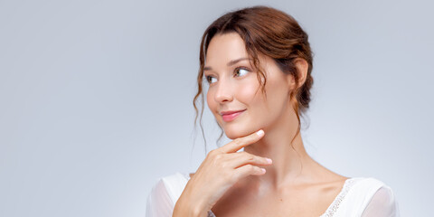 Smiling Woman Touching Chin With Gentle Expression And Healthy Glowing Skin