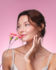 Happy Woman Holding Flowers and Touching Face in Floral Beauty Scene