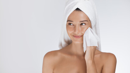 Young Woman Drying Face With Towel After Skincare Routine at Home