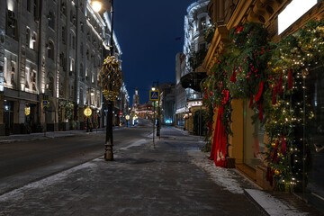 Obraz premium Night view of Petrovka street with Christmas decorations in Moscow, Russia. Architecture and landmarks of Moscow. Cozy cityscape of Moscow
