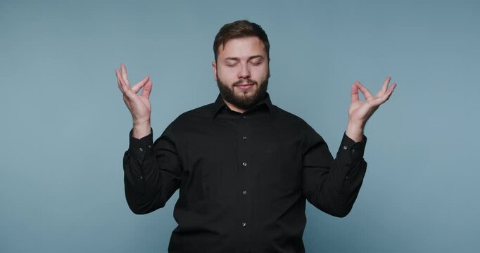 Man practices mindfulness with calm gestures in indoor setting