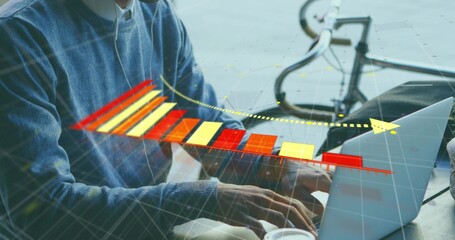 Typing man in blue sweater and collared shirt at plaza, wearing earbuds, laptop showing 3D chart