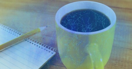 Showing yellow mug with black coffee on wooden desk, notebook, yellow pencil, blue network overlay