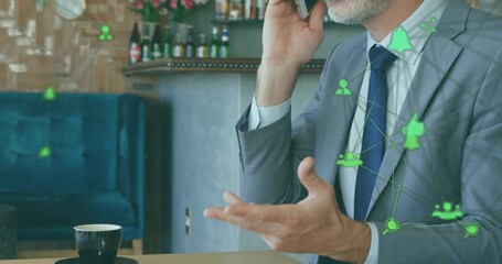 Speaking man in gray-suit striped tie at cafe table on phone gesturing, coffee, network, copy space