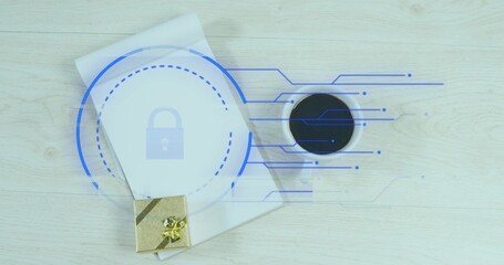 Displaying closed white notebook bearing blue lock overlay on light wood desk, gold gift and coffee