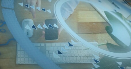 Holding adult hands with white shirt cuff tapping smartphone on wooden work desk, with keyboard