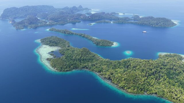 Shallow coral reefs fringe the beautiful islands of Pef, Raja Ampat, Indonesia. This region harbors spectacular marine biological diversity and is a popular destination for divers and snorkelers.