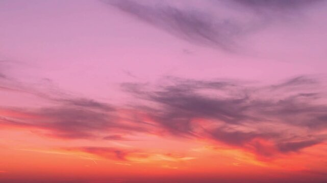 Fantasy sunset sky sun colored light feathery clouds time lapse, motion, aerial view. Evening bright color twilight skyscraper sun clouds, sunset heaven colorful firmament 4K