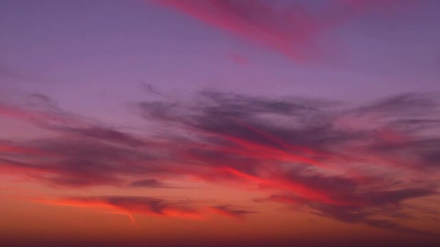 Incredible colorful sunset sky skyscraper heaven sun multi colored high feathery clouds 4K air plane window view, time lapse, fast motion, aerial drone shot.