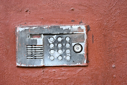old intercom at the entrance to a residential building