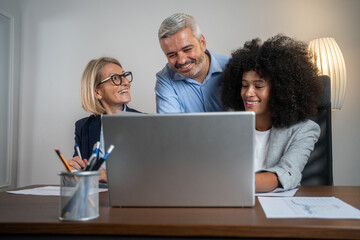 Casual meeting of smiling diverse business team analyzing financial data