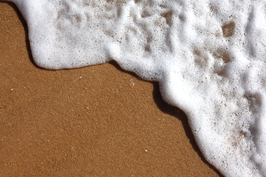 Water coming ashore on the Algarve coast, Portugal, Europe