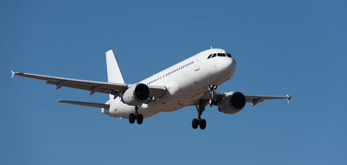 The plane lands.Airplane, passengers flying in the blue sky, preparing to land at the airport	