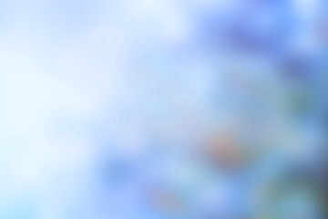 Soft blue and white abstract bokeh background with gentle light and blurry shapes