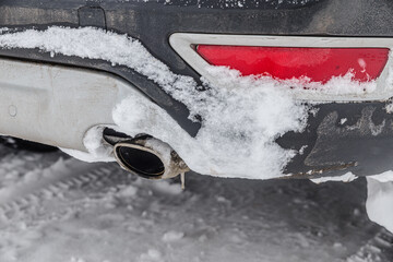The car was covered in snow and the aftermath of a snowstorm
