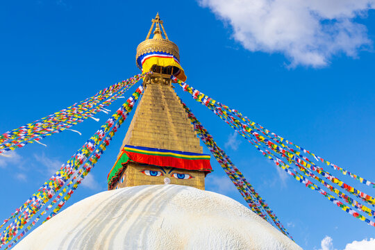 Kathmandu, Nepal. Swayambhunath Buddhist stupa. Large spherical stupa in capital of Nepa, World Heritage. Colorful Tibetian prayer flags on the top of stupa with Buddha eyes. Swoyambhu Mahachaitya