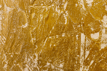 Close-up view of a golden textured Venetian plaster surface showcasing intricate patterns, ideal for backgrounds, design inspiration, or adding an elegant touch to visual projects.