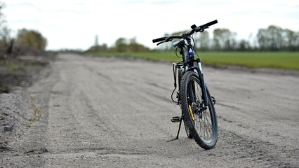 Mountain bike. stands on a field road. spring or autumn. concept of cycling, repair or breakage,...