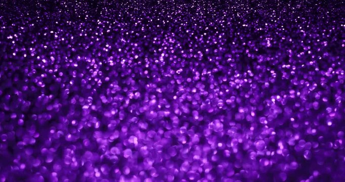 Rich purple glitter bokeh in stop-motion style with sparkling highlights and soft blur. Great for luxury, nightlife, beauty, holiday, and elegant abstract backgrounds.