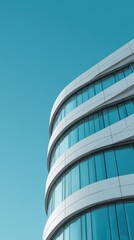 Obraz premium High quality photo of Modern curved glass office building architecture reflecting a clear blue sky from a low angle perspective