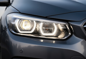 Close-up of a modern car headlight in daylight
