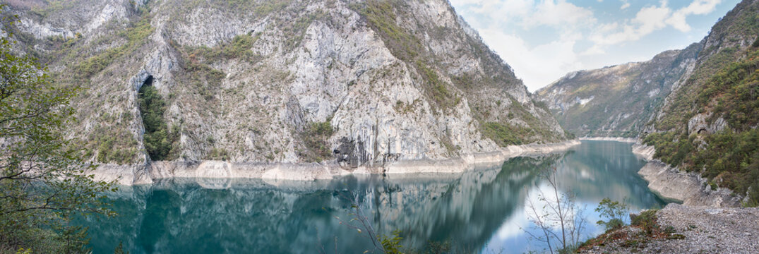 Panorama with picturesque lake and mountains. Piv Lake in Montenegro.