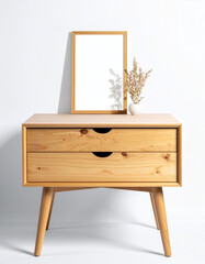 front view of wooden table with blank portrait picture frame and vase on white background with soft shadow
