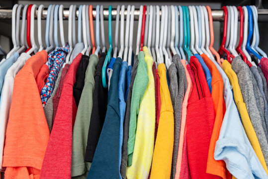 Colorful Assorted Cotton T-Shirts Hanging on Closet Rack Close Up