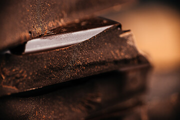 Dark chocolate pieces close up with rich texture and shallow depth of field