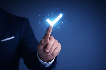 Businessman hand touching virtual blue check mark icon for approved correct choice and quality control verification standard successful completion concept on dark background