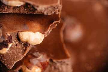 Milk chocolate with nuts macro close up and soft focus background