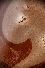 Hot chocolate foam texture close up with abstract creamy surface