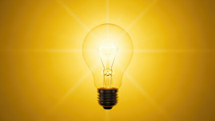 Bright Incandescent Light Bulb Glowing Against a Vibrant Yellow Background.