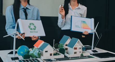 Hands of adult Asian business professionals analyzing ESG financial data and renewable energy project plans